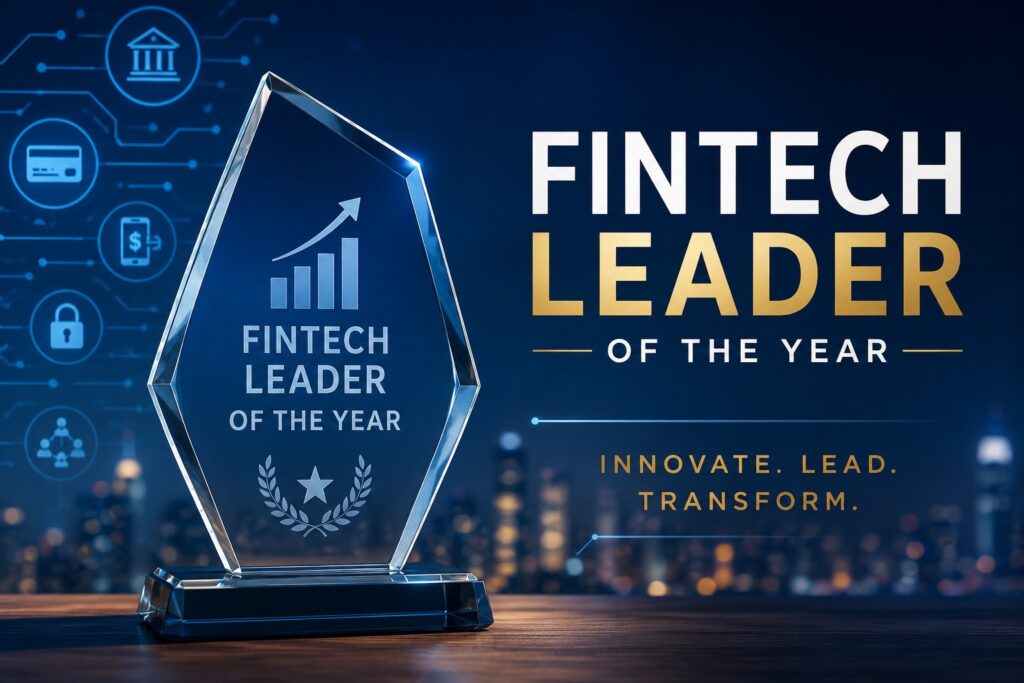 A sleek, modern award graphic celebrates excellence in financial technology with a sophisticated corporate aesthetic. A crystal trophy engraved with the words "Fintech Leader of the Year" stands prominently on a polished dark wood surface, featuring an upward-trending bar chart and arrow symbolizing innovation and growth. Behind the award, a softly blurred city skyline at dusk creates a premium business atmosphere, while glowing fintech-themed icons—representing digital banking, payments, cybersecurity, financial institutions, and connected technology—float against a deep navy blue background. Large white and gold typography reading "FINTECH LEADER OF THE YEAR" dominates the right side of the image, complemented by the tagline "Innovate. Lead. Transform." The overall design conveys prestige, leadership, and cutting-edge innovation, making it ideal for illustrating an industry award or recognition in the fintech sector.