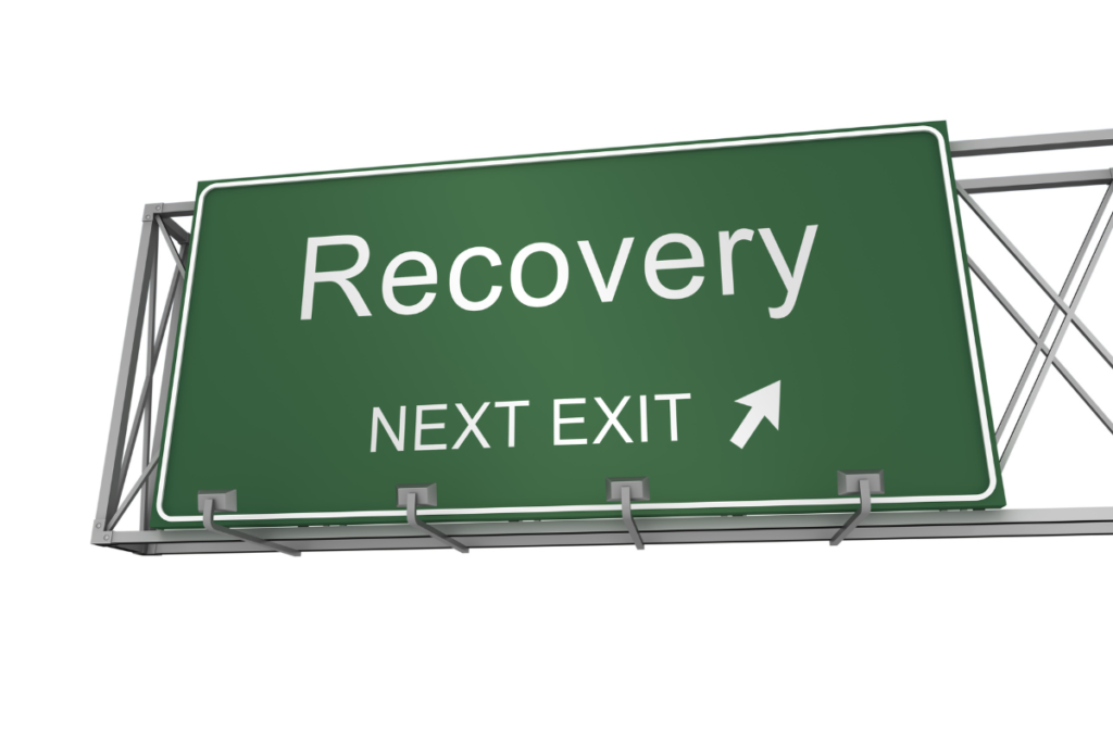 Road sign with "Recovery Next Exit" written on it