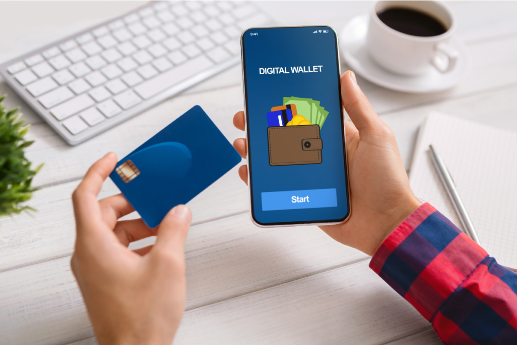 Person holding credit card and smartphone; digital banking app on smartphone screen